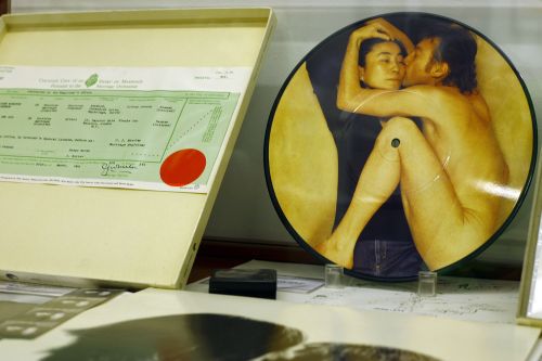 A picture of a copy of the marriage certificate of John Lennon and Yoko Ono and a CD of the couple is displayed at the Beatles museum in Buenos Aires. (AFP-Yonhap News)