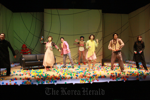 Actors and actresses throw rubber balls at the audience near the end of the play “La Cantatrice Chauve.” (Aga Company)
