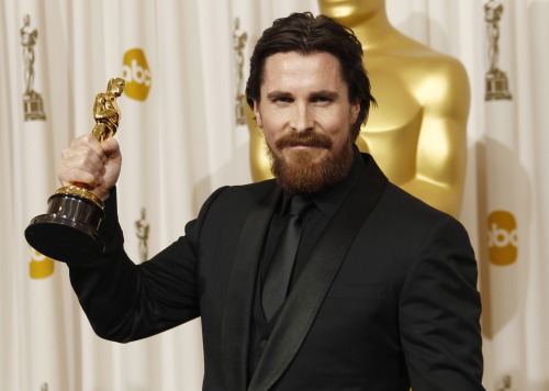 Christian Bale poses backstage with the Oscar for best performance by an actor in a supporting role for 
