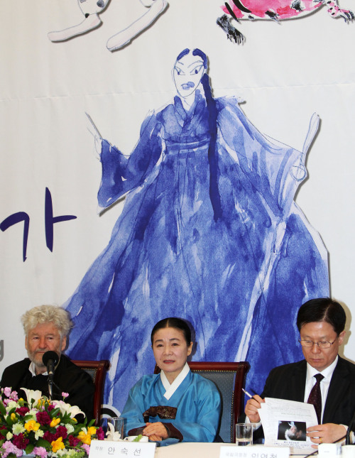 (From left) Opera director Achim Freyer, singer Ahn Suk-seon and Lim Youn-churl, president of the National Theater of Korea, sit in front of a painting of Ahn by Freyer at the Press Center in Seoul on Monday. (Yonhap News)