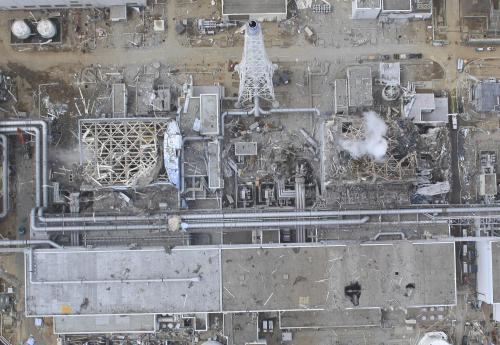 In this March 20, 2011 aerial photo taken by small unmanned drone and released by AIR PHOTO SERVICE, damaged Unit 4, left, and Unit 3 of the crippled Fukushima Dai-ichi nuclear power plant are seen in Okumamachi, Fukushima prefecture, northern Japan. (AP-Yonhap)
