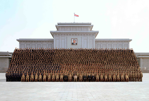 This undated photo shows North Korean leader Kim Jong-il (center, front row) attending a photo session with a group of elite soldiers in front of the Kumsusan Memorial Palace in Pyongyang. (KCNA-Yonhap news)