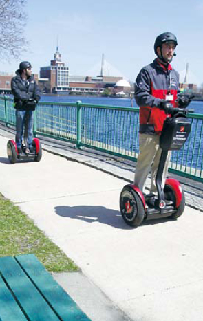 Museum of Science twowheel,gyroscopic, personal transporter tour guide Nick Rosato (right), of Boston escorts Waldo Holtzhausen on a tour route along the Charles River in Cambridge, Massachusetts, April 15.(AP-Yonhap News)