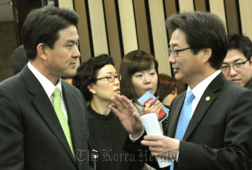 Newly elected Kim Tae-ho (left) and party leader secretary Won Hee-mok of the ruling Grand National Party exchange opinions during the in-party debate Monday morning. (Yang Dong-chul/The Korea Herald)
