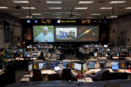 Video feeds in Misson Control at Johnson Space Center show Pope Benedict XVI in the Vatican talking with astronauts on the International Space Station Saturday morning May 21, 2011 in Houston. Cardinal Daniel DiNardo lead a Houston delegation of church leaders who witnessed the phone call from the Mission Control observation room. (AP)