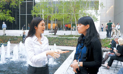 Lee Dong-jae (left) and Joo Hye-na, who were MoMA interns from January to April, talk in MoMA’s sculpture garden in New York. (Kim Yoon-mi/The Korea Herald)