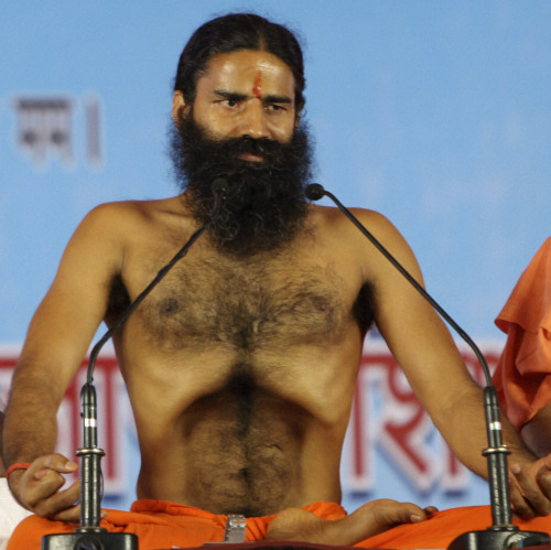 Renowned yoga guru Baba Ramdev performs Yoga exercises before going on a hunger strike with his followers in New Delhi on Saturday. (AP-Yonhap News)