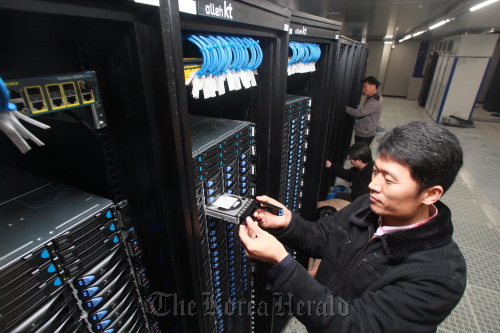 An employee at KT Corp. checks the server located inside the company’s Cloud Data Center in Cheonan. (KT Corp)