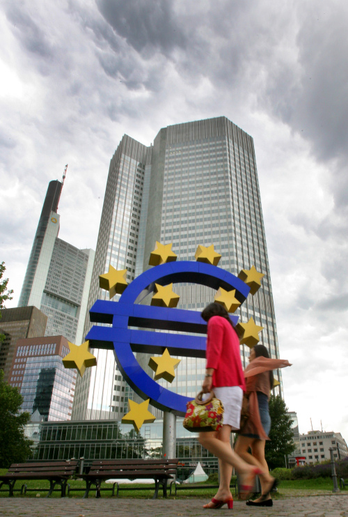 Pedestrians pass a euro sign sculpture outside the European Central Bank headquarters in Frankfurt, Germany, on Thursday. (Bloomberg)