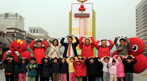 Seoul Mayor Oh Se-hoon (third from left in the back row), charity officials and children join a ceremony to kick off a donation campaign at Gwanghwamun Square. (Ahn Hoon/The Korea Herald)