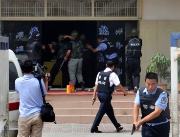 Armed policemen try to rescue hostages at a police station during a clash in Hotan, Xinjiang, July 18. (Xinjiang Public Security Bureau)