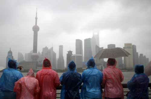 Tourists in colorful rain coats visit the Bund to view the city’s famous skyscrapers across the Huangpu River in Shanghai. (AP-Yonhap News)