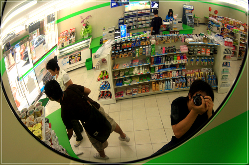 The interior of a Seoul convenience store is reflected in a convex mirror. Hit hard by high consumer prices, more South Koreans appear to be shopping at convenience stores. (The Korea Herald)