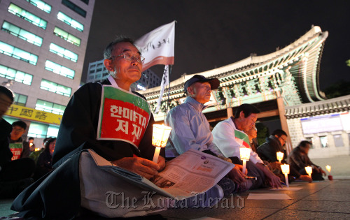 Opponents of the Korea-U.S. free trade pact protest in front of Seoul City Hall on Wednesday night. (Yonhap news)