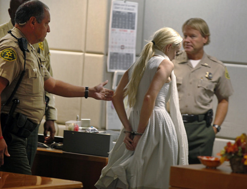 Lindsay Lohan is taken into custody by Los Angeles Country sheriffs after a judge finds her in violation of probation Wednesday, Oct. 19, 2011, in Los Angeles. (AP)