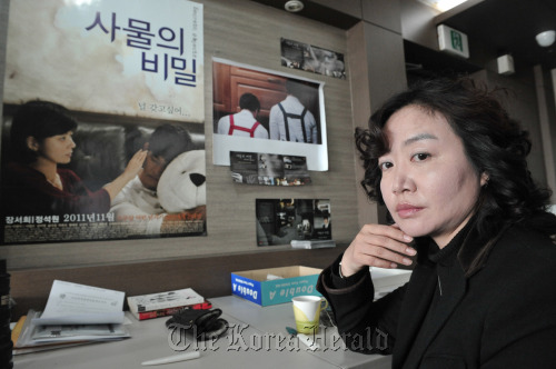 Director Lee Young-mi poses in the office of her production company, Film Front, in Seoul, Friday. (Chung Hee-cho/The Korea Herald)