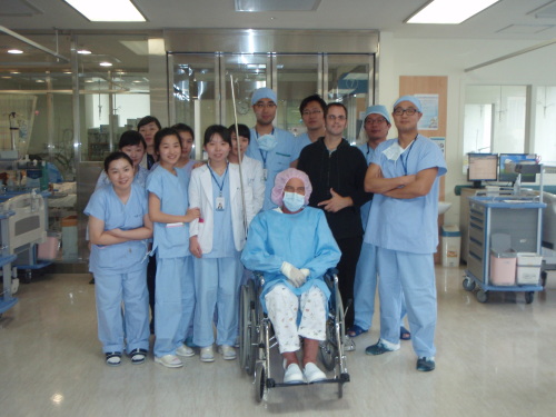Mick Milne (in wheelchair) and his brother Randall are pictured with members of the organ transplant team at Pusan University Hospital shortly after his operation.