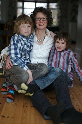 Caroline Swain poses for a photo with her sons Max (left), 10, and Luke, 9, at their home in Rayleigh, England. (AP)