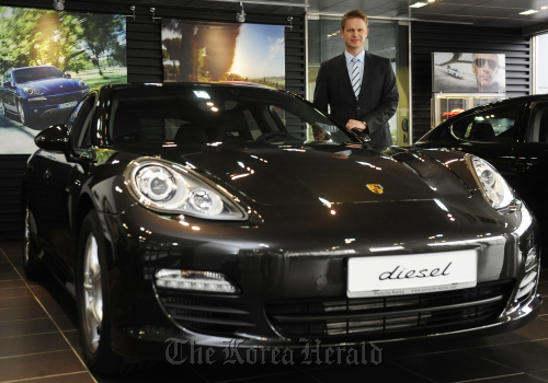 Porsche President and Joint Representative Michael Vetter poses with one of their hottest sellers, the Panamera diesel (The Korea Herald)