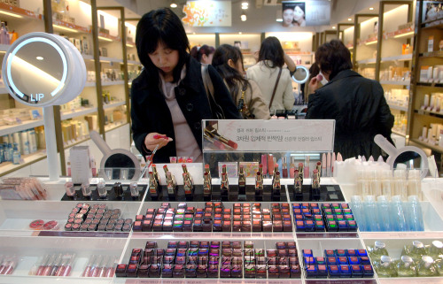 Customers look through cosmetics at a shop in Seoul. (Bloomberg)