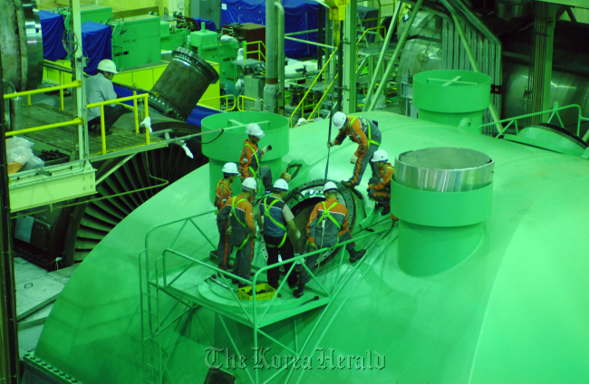 Engineers check turbine generator systems at the Kori-1 plant. (KNHP)