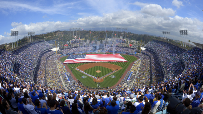 Fans sing the national anthem ahead of the game between the Los Angeles Dodgers and the San Francisco Giants at Dodger Stadium on Monday. (AP-Yonhap News)
