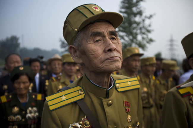 North Korean veterans of the Korean War enter a cemetery for Korean War veterans on Thursday, July 25, 2013 in Pyongyang, North Korea during an opening ceremony marking the 60th anniversary of the signing of the armistice that ended hostilities on the Korean peninsula. (AP-Yonhap News)