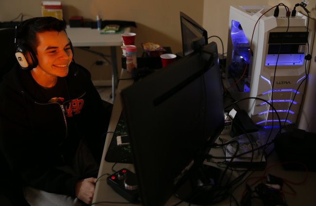 Matt “Nadeshot” Haag, 21, jokes with his off-site teammates while playing in a “Call of Duty” tournament at his Chicago northwest suburban home on Jan. 19. (Chicago Tribune/MCT)