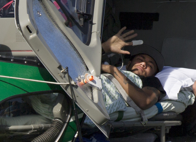 Brazil`s Neymar waves from inside a medical helicopter at the Granja Comary training center, in Teresopolis, Brazil, Saturday. (AP)