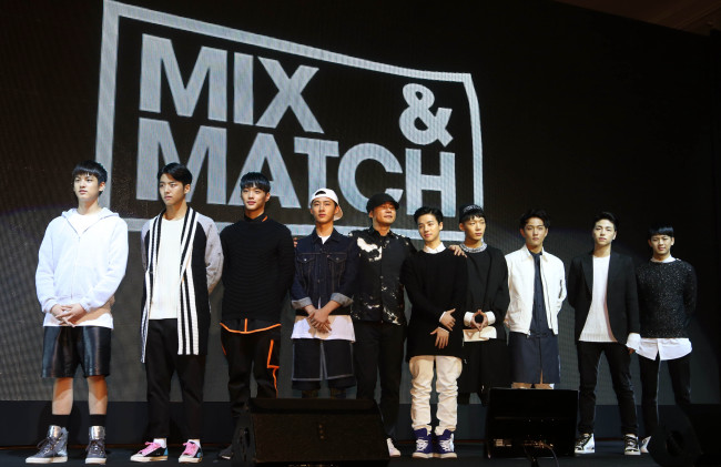 YG Entertainment founder Yang Hyun-suk (center) poses along with the nine trainees who will participate in the upcoming boy band survival program “Mix & Match” at a press conference in Seoul on Tuesday. (Yonhap)