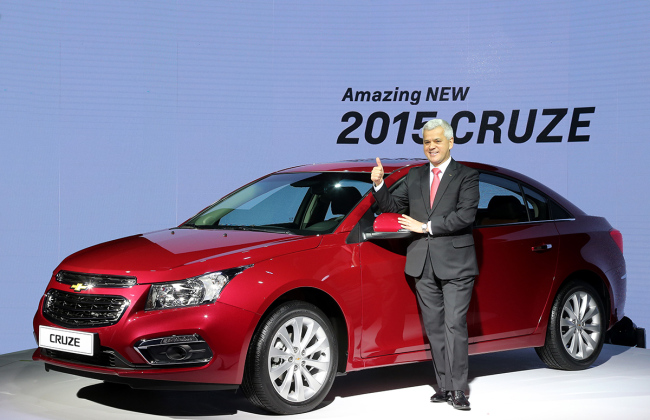 Sergio Rocha, president and CEO of GM Korea, poses in front of the “Amazing New 2015 Cruze,” which presents an updated exterior on the best-selling Chevrolet car line. The car began preorders Thursday before its sale in February. (GM Korea)