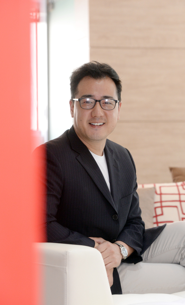 Richard Choo, CEO of KPOP UNITED, poses before an interview with The Korea Herald at the company’s office in southern Seoul. (Ahn Hoon/The Korea Herald)