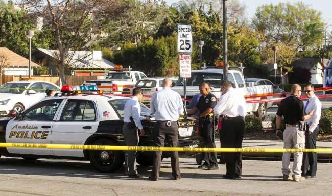 Police officers investigate the scene near Pearson Park in Anaheim, California, on Feb. 27 after three counter-protesters were stabbed while clashing with Ku Klux Klan members staging a rally. Thirteen people were arrested.AFP