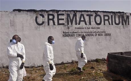 Health workers prepare to collect the ashes of people that died due to the Ebola virus at a crematorium on the outskirts of Monrovia, Liberia. As Liberia marks the second anniversary Wednesday of its first confirmed Ebola cases, many neighbors say they want to see the crematorium torn down so they can try to forget that terrible time. (AP-Yonhap)