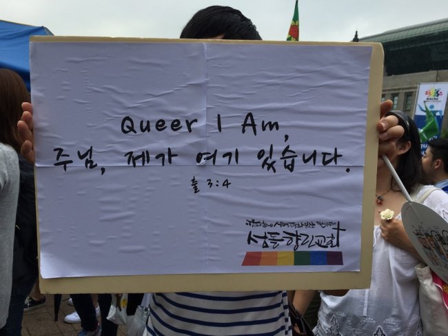 Kim Jeong Woong-Ki, a church-goer, holds up a placard reading 