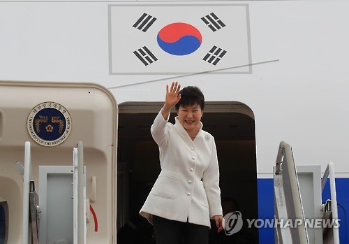 President Park Geun-hye waves as she boards her plane at the military airport in Seongnam, just south of Seoul, on Sept. 2, 2016, to depart for Russia's Far East port city of Vladivostok to attend an economic forum and a summit with her Russian counterpart Vladimir Putin. Park's visit to Russia is part of her eight-day trip that will also takes her to China and Laos. 