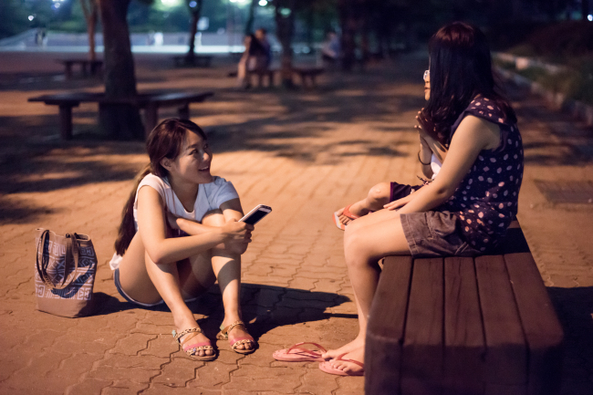 A Humans of Seoul team member interviews a subject for the online blog. (Humans of Seoul)