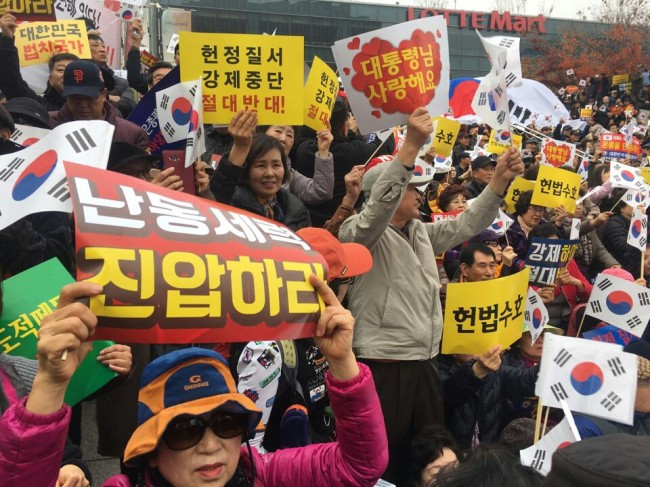 People participating in a pro-Park rally hold signs reading 