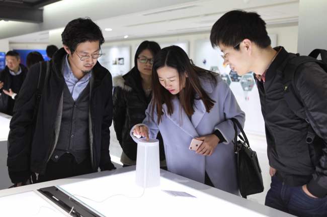 Reporters check out a voice controlled device developed by a Chinese company in Zhongguancun InnoWay in Beijing on Nov. 8. (Park Ga-young/The Korea Herald)