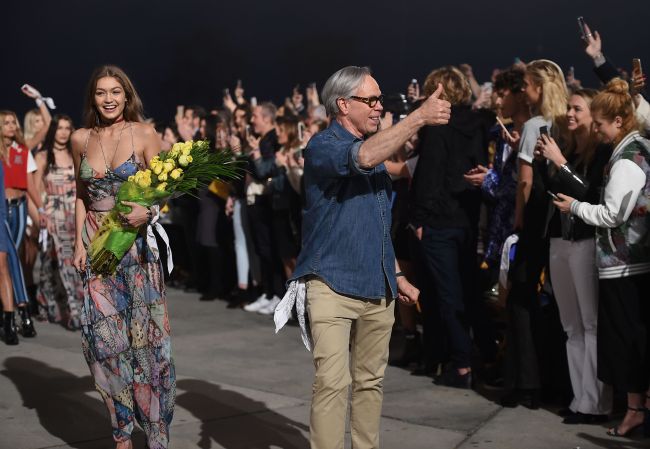 Gigi Hadid (left) and fashion designer Tommy Hilfiger (right) walk the runway at the TommyLand Tommy Hilfiger Spring 2017 Fashion Show on the boardwalk in Venice, California, Wednesday. AFP-Yonhap