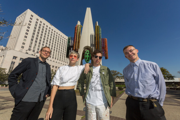 From left: Tanner Blackman, Claire Evans, Jona Bechtolt and Tom Carroll, members of the Triforium project, pose with Joseph L. Young’s Triforium, a “polyphonoptic” public sculpture, at the Fletcher Bowron Square in downtown Los Angeles on Feb. 1. (AP-Yonhap)