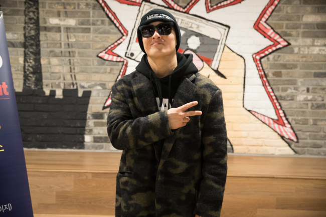 caption: MC Sniper poses for a photo after participating in a press event for Korea Creative Content Agency’s “K-Pop Night Out” on Tuesday in Seoul. (Korea Creative Content Agency)