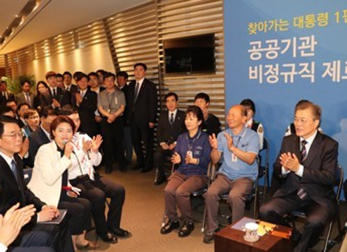 President Moon Jae-in (right) claps during a meeting with employees of Incheon International Airport Corp. on May 12, 2017. Moon pledged to turn all temporary jobs in the public sector into regular, full-time ones while in office. (Yonhap)