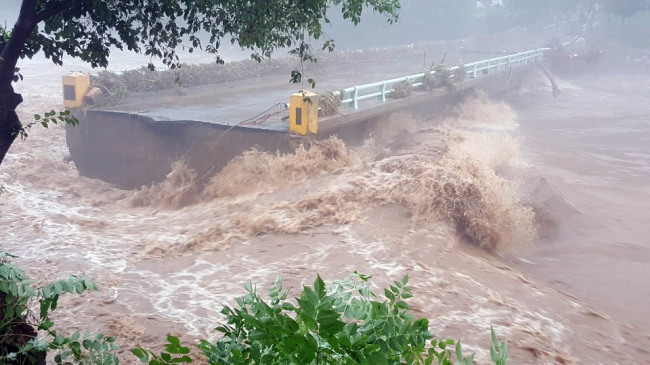 A bridge is destroyed in Hongcheon Country in Gangwon Province where 343 millimeters of rain fell overnight. (Yonhap)