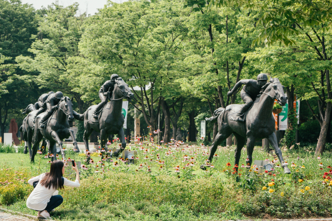 Statues are seen at forests in Seoul.