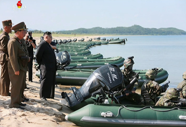 The image captured from the official Korean Central Television shows North Korean leader Kim Jong-un (center) overseeing a drill of special forces units, designed to seize Baengnyeongdo and Yeonpyeongdo, two of the five major South Korean islands near the inter-Korean border in the West Sea. (Yonhap)