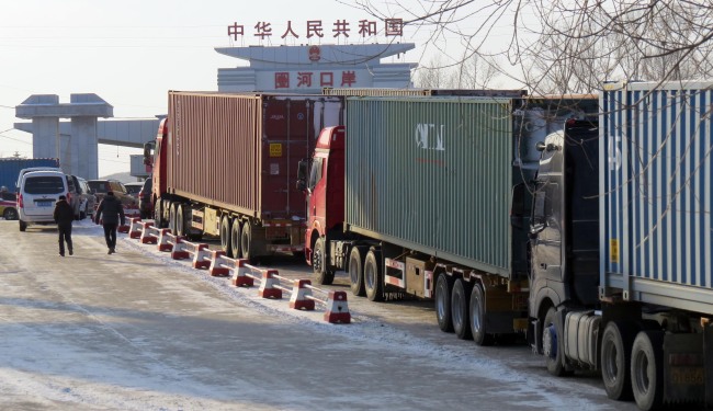 A line of Chinese shipping container trucks are waiting to enter North Korea. (Yonhap)