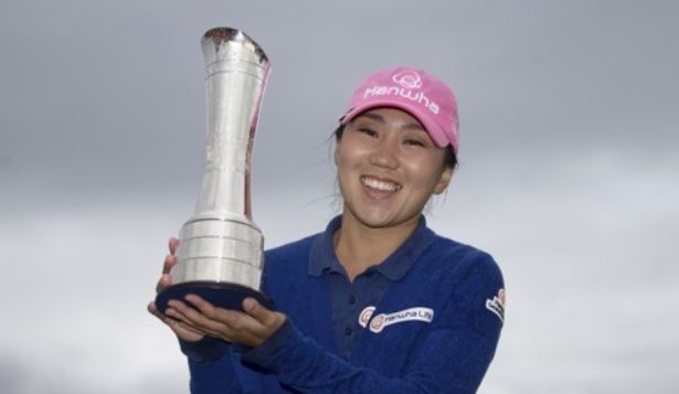 In this Associated Press file photo taken Aug. 6, 2017, Kim In-kyung of South Korea celebrates with the champion`s trophy after winning the Ricoh Women`s British Open at Kingsbarns Golf Links in Fife, Scotland. (Yonhap)