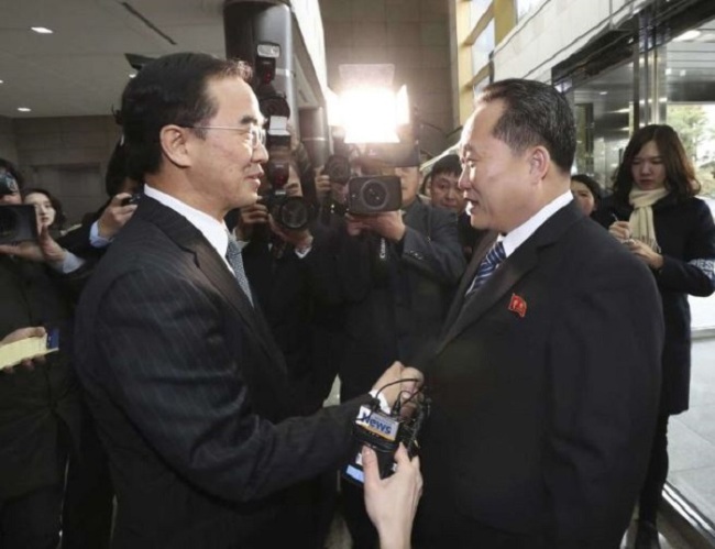 South Korean Unification Minister Cho Myoung-gyon, left, shakes hands with the head of North Korean delegation Ri Son Gwon before their meeting at the Panmunjom in the Demilitarized Zone in Paju, South Korea, Tuesday, Jan. 9, 2018. (AP-Yonhap)