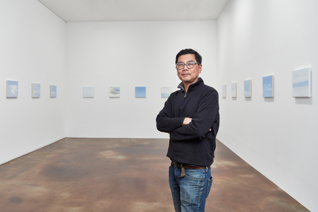 Byron Kim poses with his Sunday Painting series at Kukje Gallery in Seoul (Kukje Gallery)